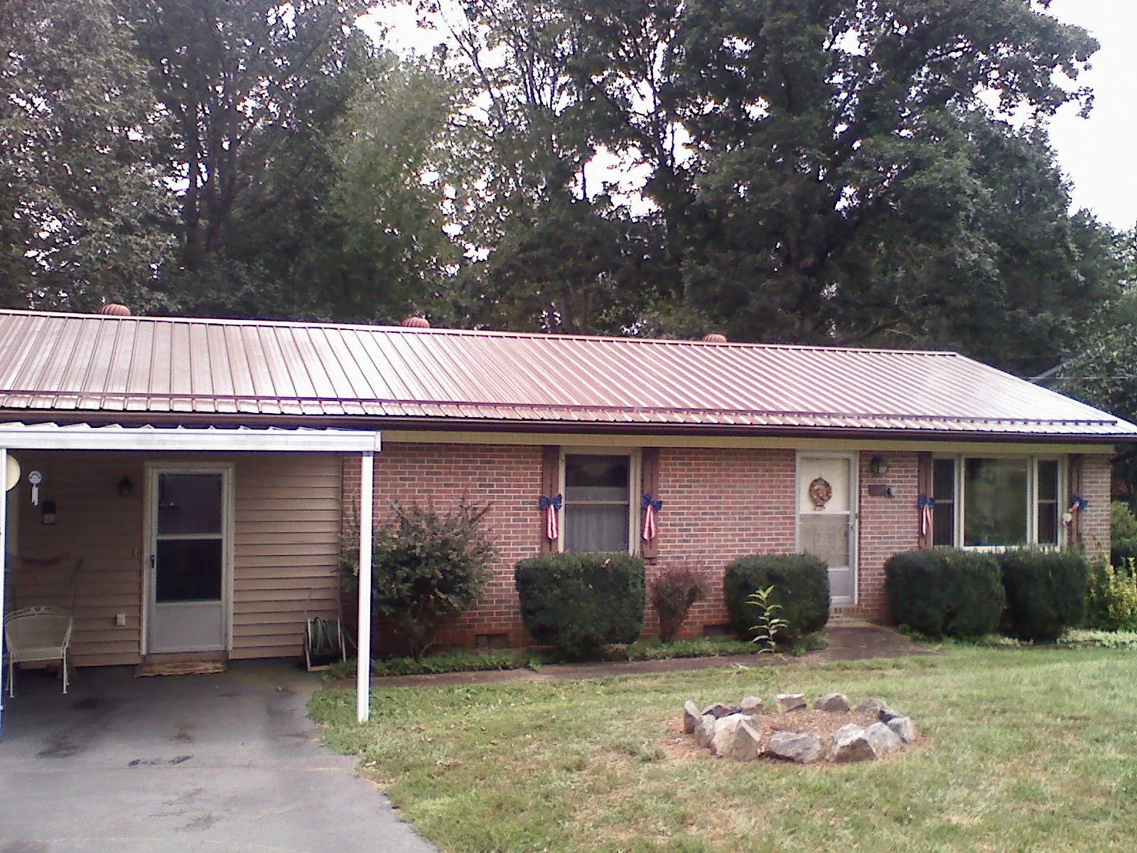 Bronze metal roof and carport on a brick ranch home — Roof Repair work by our crew in Smiths Grove